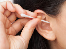 Woman cleaning ear